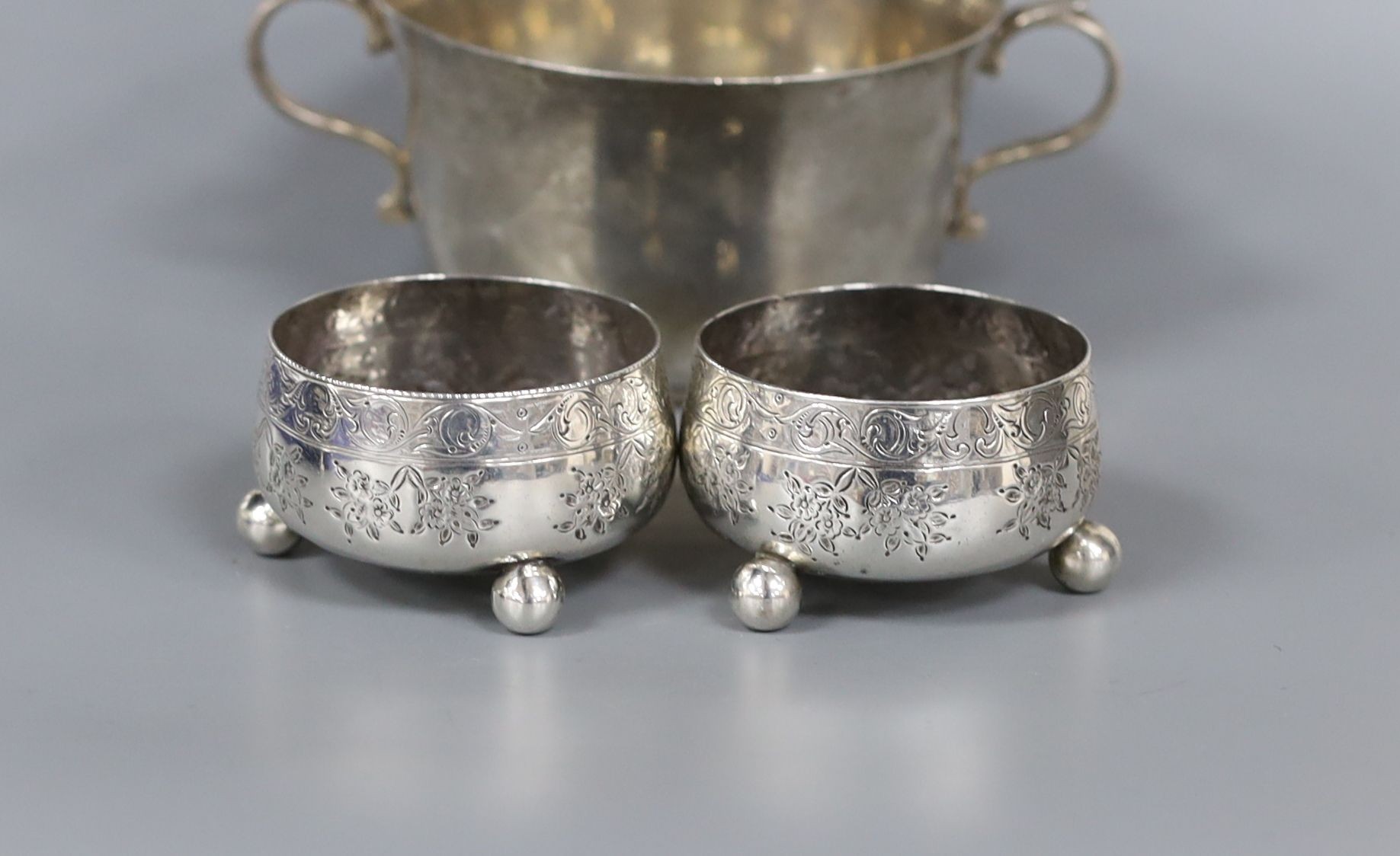 A silver sugar bowl, pair of silver bun salts and a silver mustard pot.